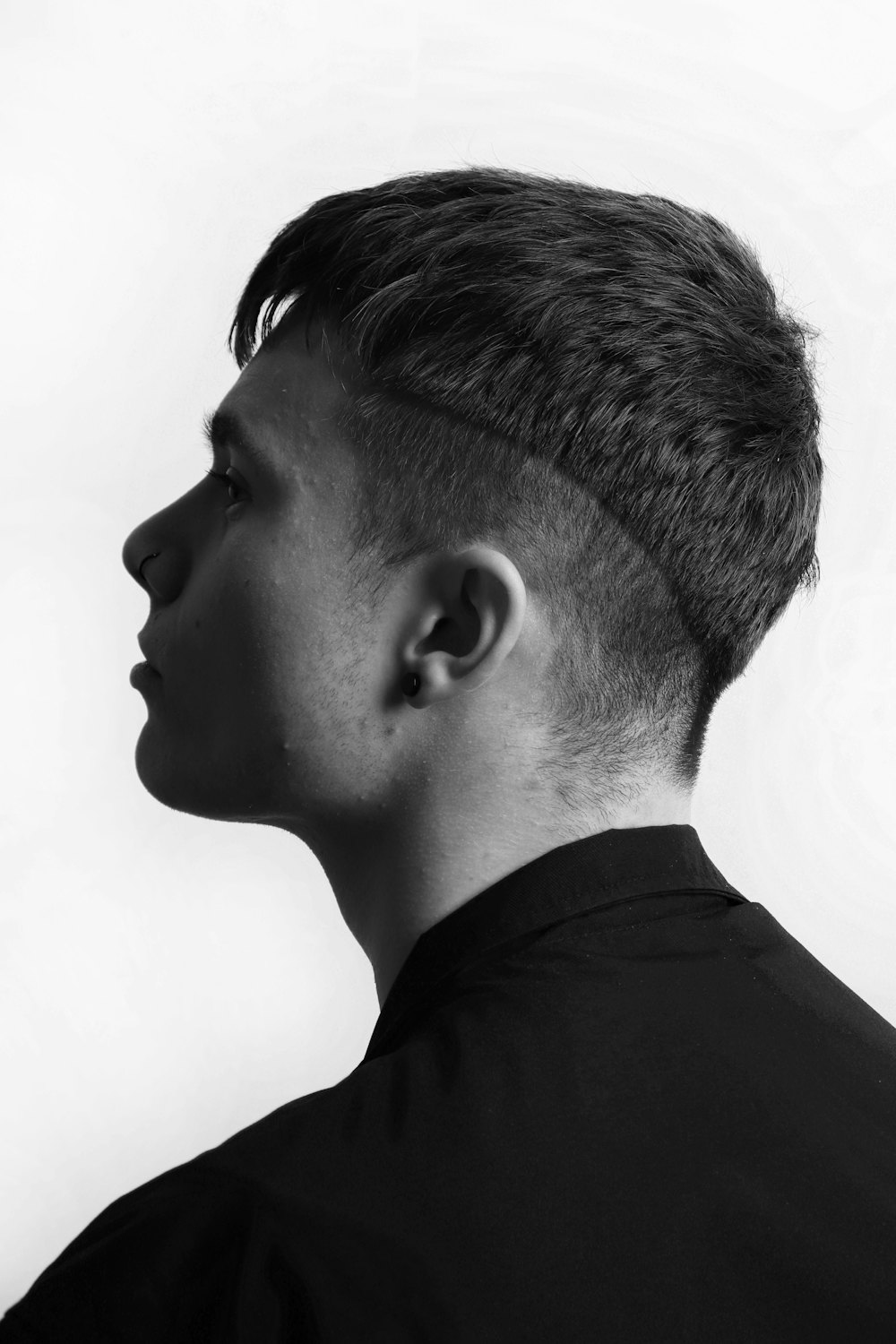 Black and white portrait of a young man with a taper